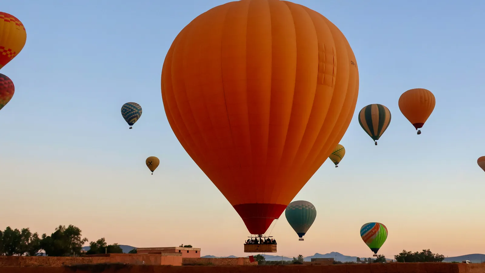 Hot-air balloons at sunrise over Marrakech