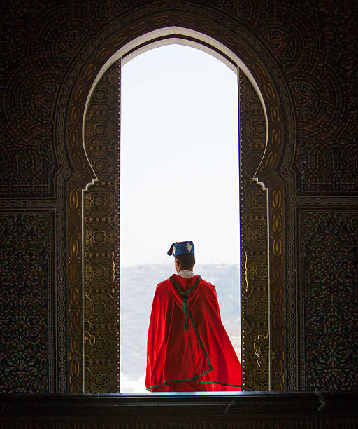 A figure in white in a sunlit Marrakech doorway